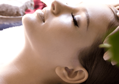 Beautiful woman relaxing and getting head massage.